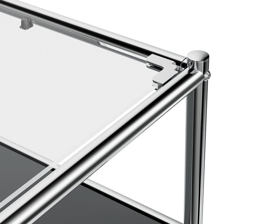 Détail du meuble bas en métal gris «
CN3
» avec abattant et plateau de verre.