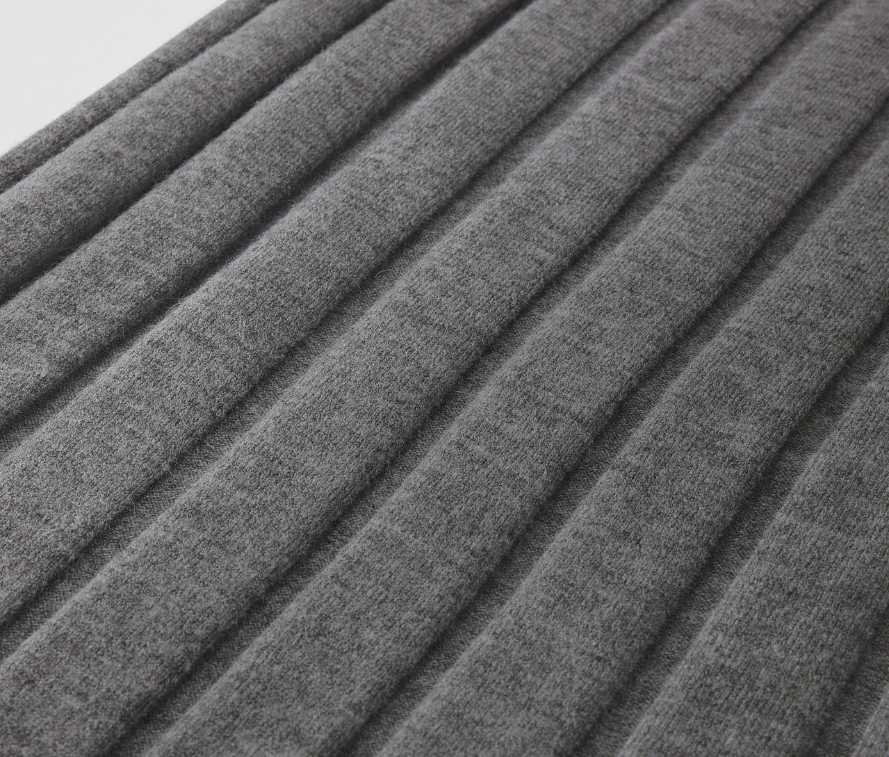 Gros plan d'un tissu plissé gris.