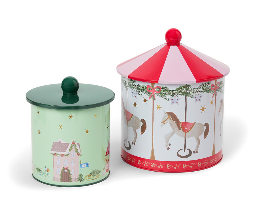 Deux boîtes en métal avec des motifs de Noël, l'une avec une maison et l'autre avec un cheval de carrousel.