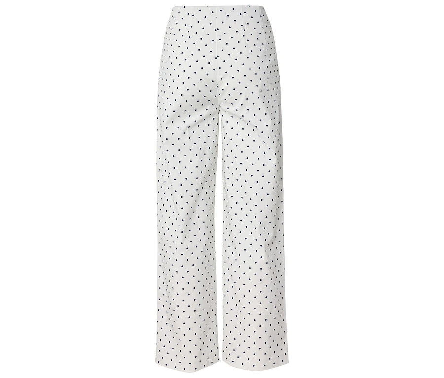 Pantalon blanc à pois noirs.