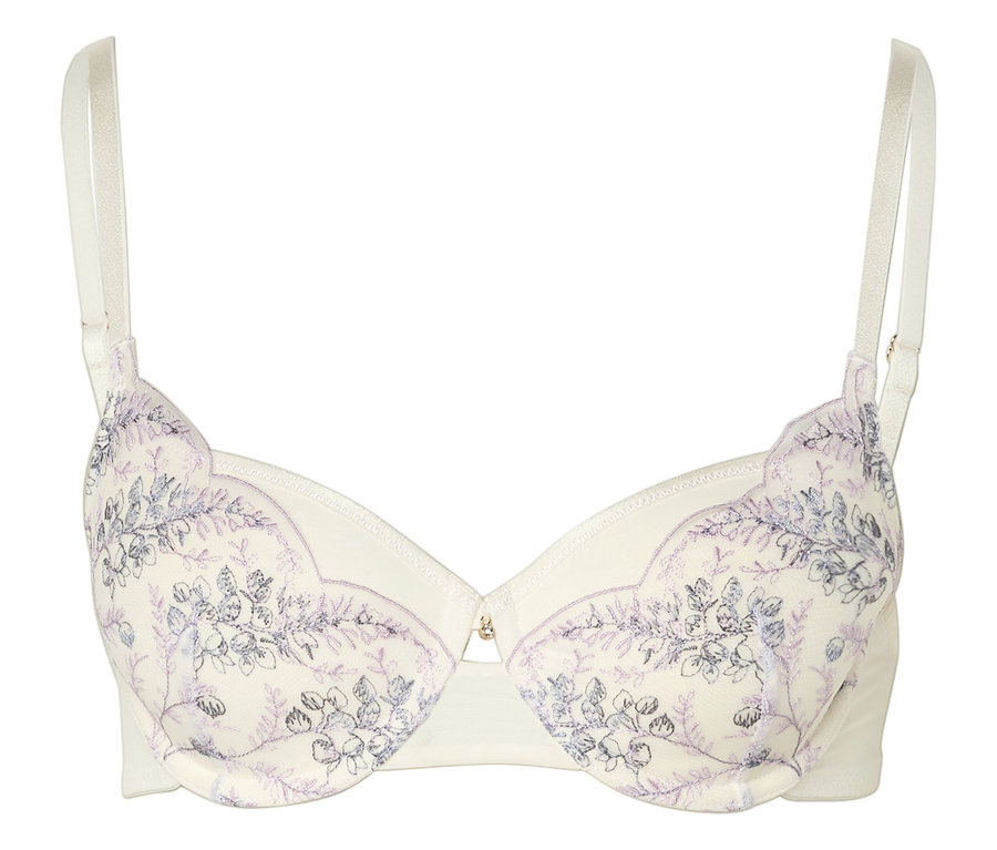 Soutien-gorge couleur ivoire avec broderies florales et bretelles réglables.