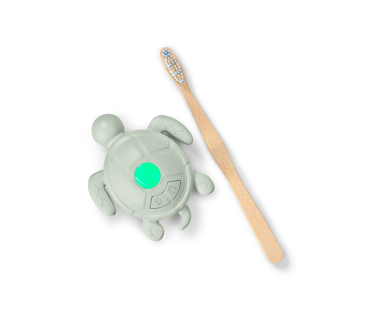 Un minuteur pour se laver les mains et les dents en forme de tortue avec une lumière verte et une brosse à dents en bois.
