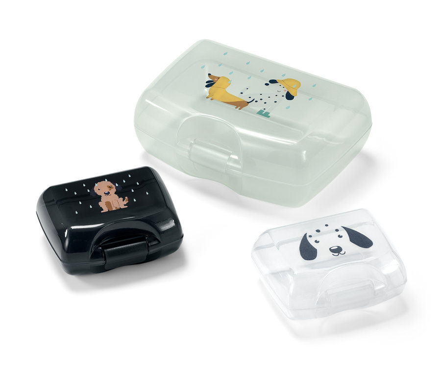 Trois boîtes à lunch avec des motifs de chiens.