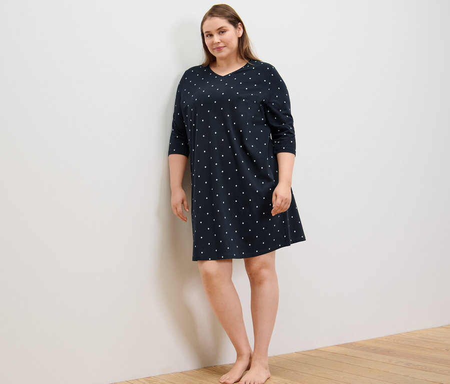 Femme debout portant une chemise de nuit.
