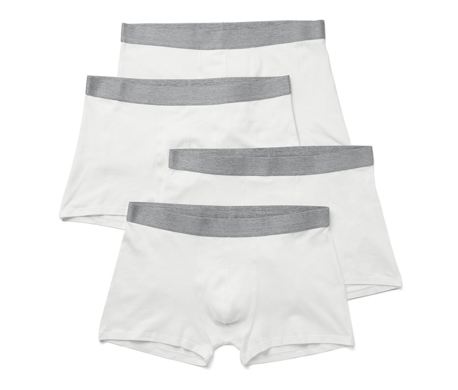 Quatre boxers blancs avec ceinture grise.