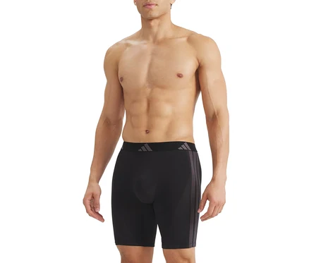 Homme torse nu portant un boxer noir avec une ceinture noire, un logo gris et trois rayures grises sur le côté.