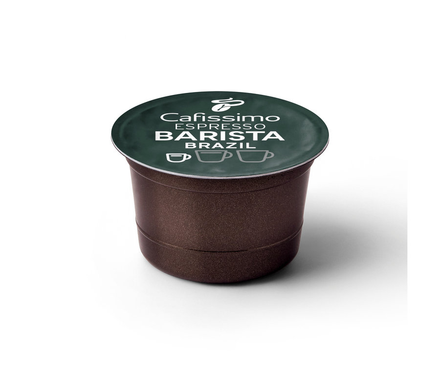 Une capsule de café Cafissimo BARISTA Espresso Brasil marron avec un couvercle vert foncé. Le couvercle porte le texte blanc 'Cafissimo ESPRESSO BARISTA BRAZIL', un logo Tchibo et trois icônes de tasses à café.
