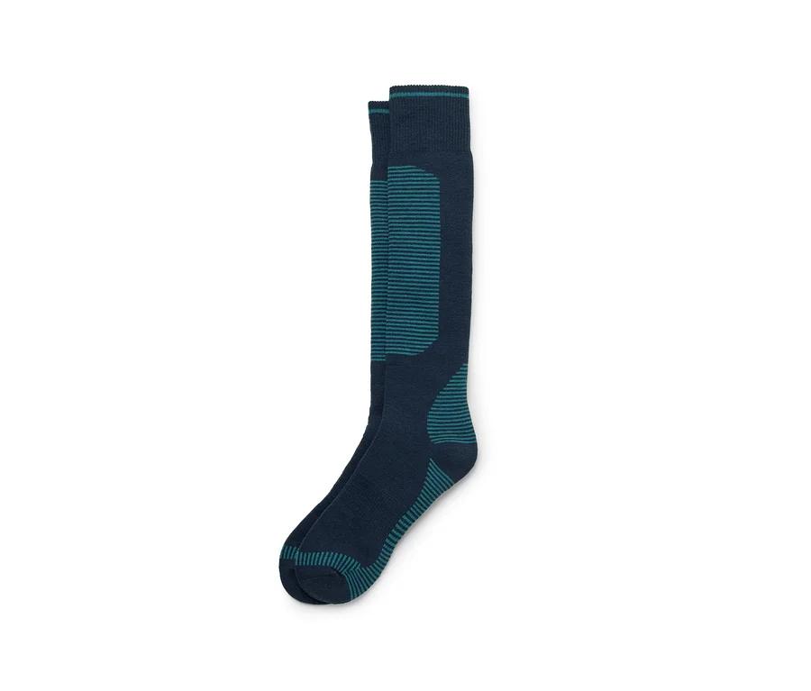 Une paire de chaussettes montantes bleu marine avec des rayures et des accents turquoise, sur fond blanc.