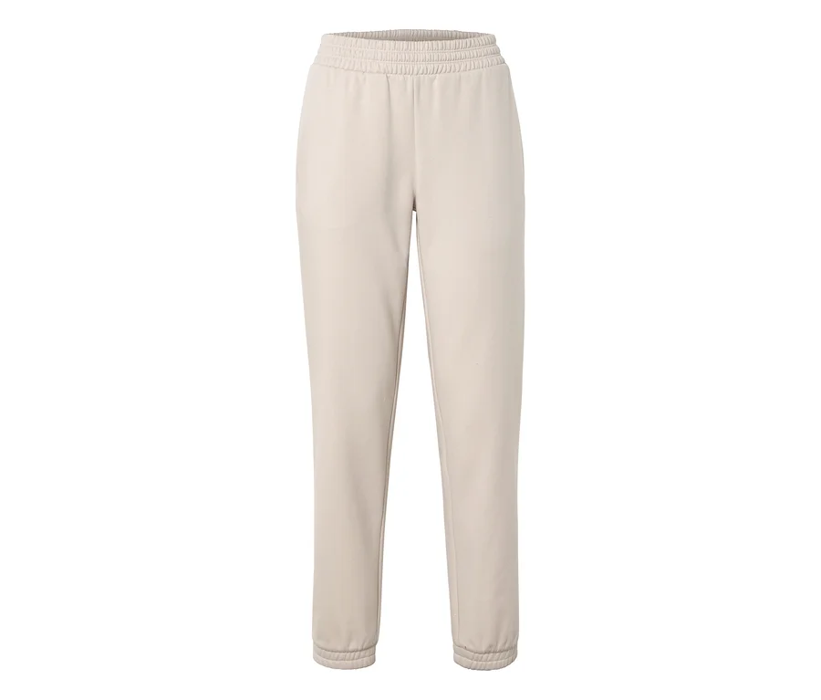 Pantalon de jogging beige avec taille et chevilles élastiquées.