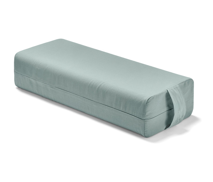 Un bolster de yoga vert clair.