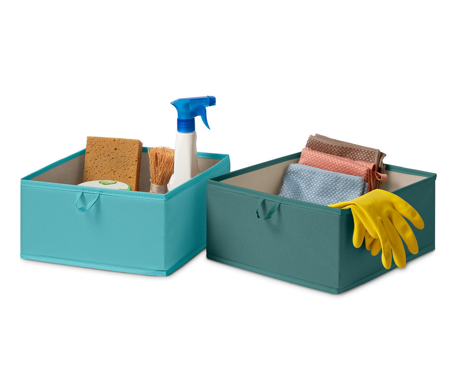 Deux grandes boîtes de rangement pour tiroir, une bleue avec des produits de nettoyage et une verte avec des chiffons et des gants.