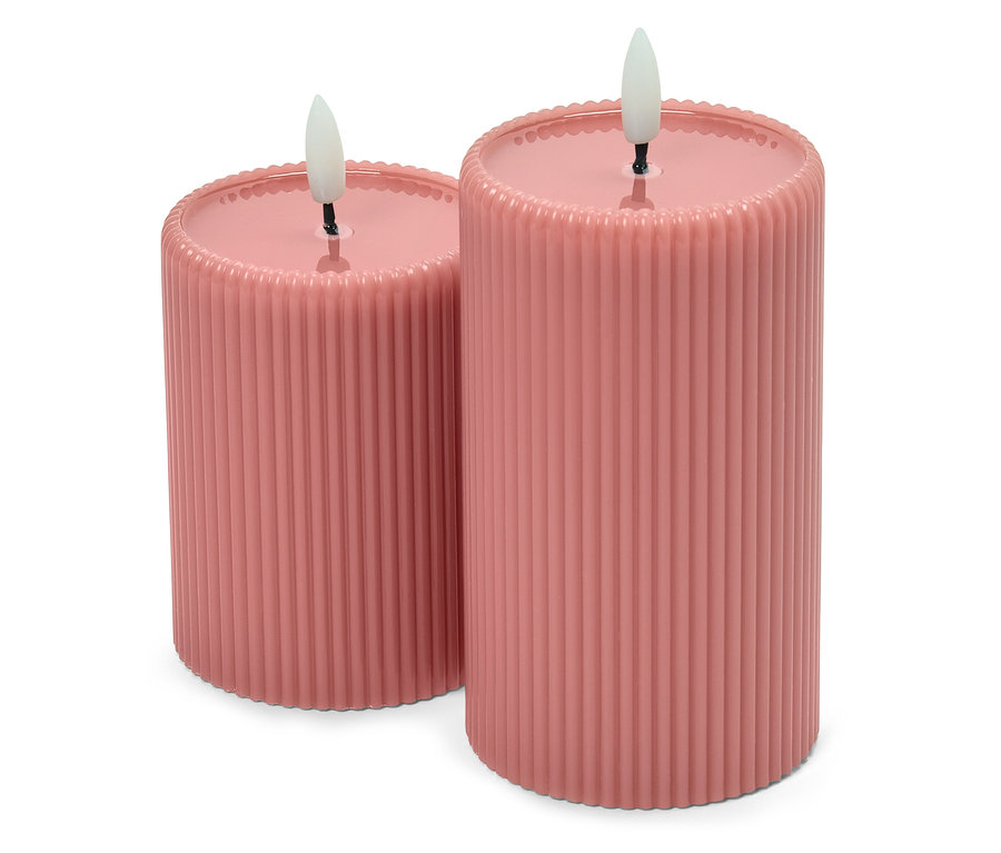 Deux bougies piliers roses avec une surface côtelée et des flammes LED.