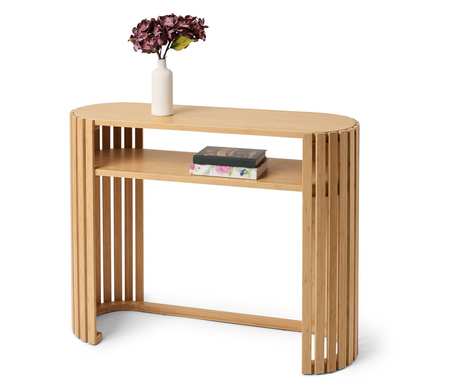 Table en bambou avec des fleurs dans un vase et des livres sur l'étagère.