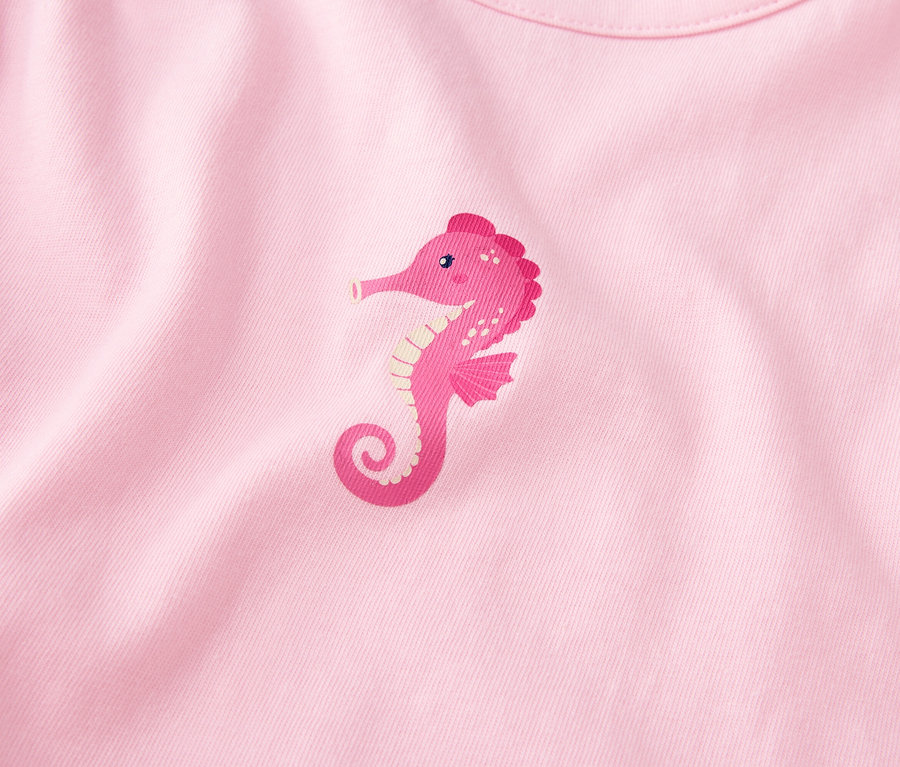 Gros plan sur un tissu rose avec un hippocampe rose imprimé.