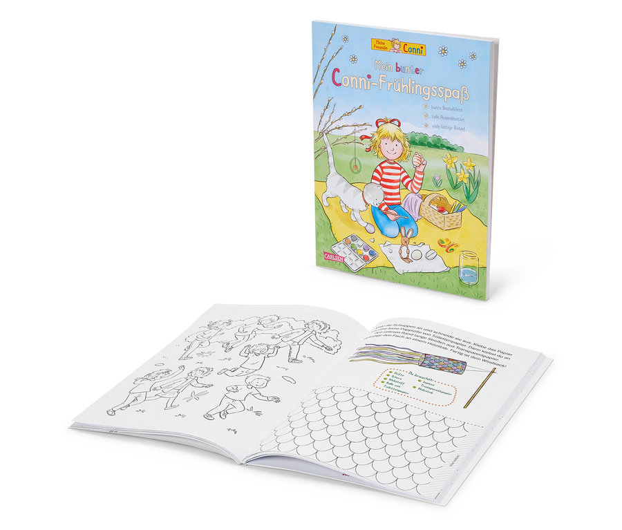 Deux livres pour enfants sont posés l'un sur l'autre ; celui du dessus représente un personnage de dessin animé blond assis avec un chat sur une couverture jaune.