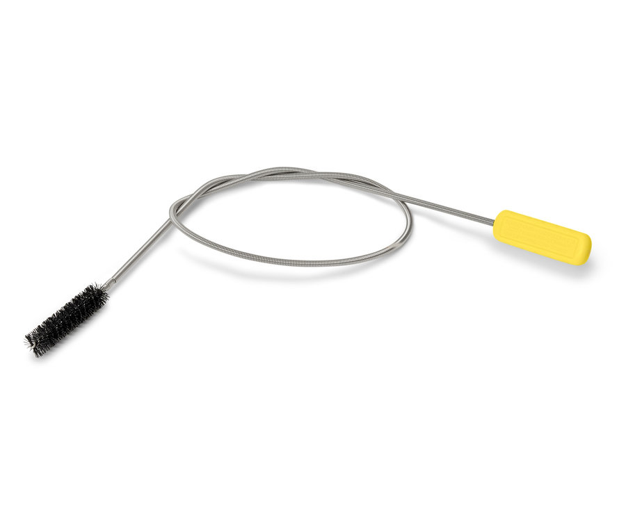Une brosse flexible avec une poignée jaune repose sur un fond blanc.