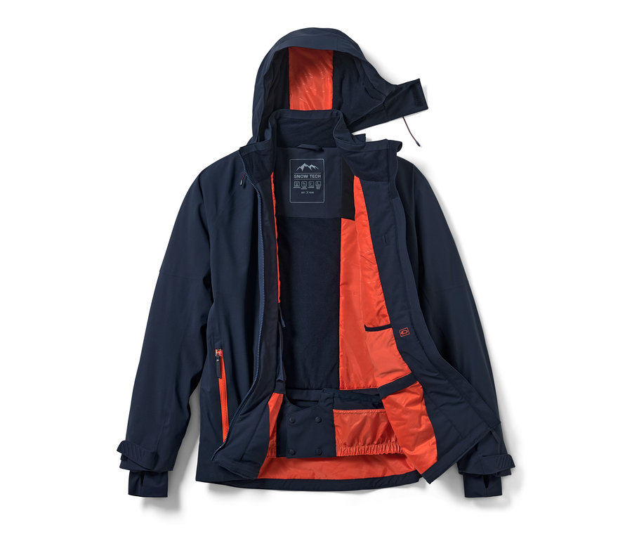 Veste de ski high-tech bleu marine ouverte avec doublure orange.