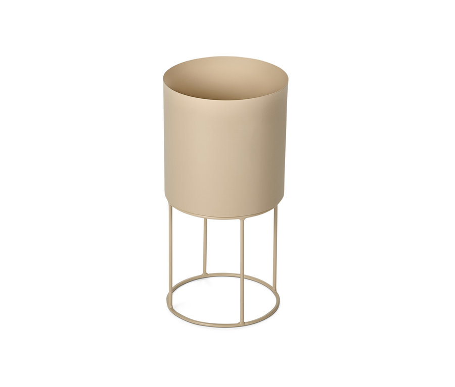 Un cache-pot rond beige sur un support métallique.