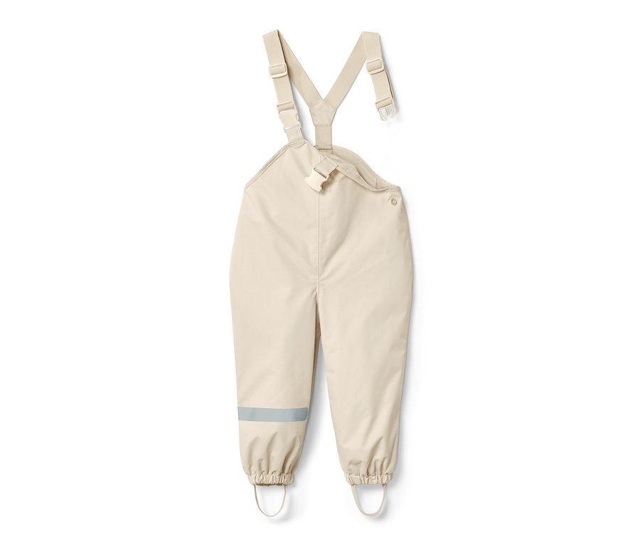 Pantalon imperméable sable pour tout-petit avec bretelles et bande réfléchissante sur la jambe.