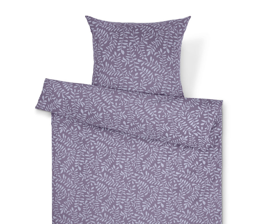 Linge de lit violet avec motif de feuilles et oreiller.