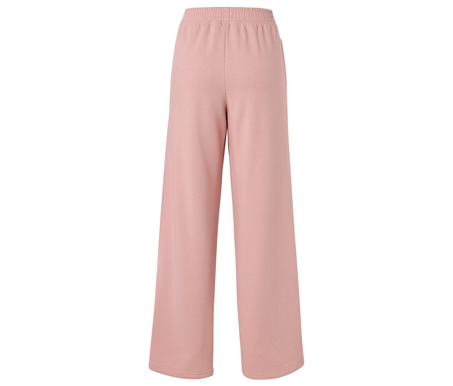 Pantalon rose large avec élastique à la taille, isolé sur fond blanc.