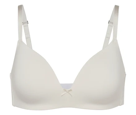 Gros plan d'un soutien-gorge blanc avec bretelles réglables et un nœud au centre.