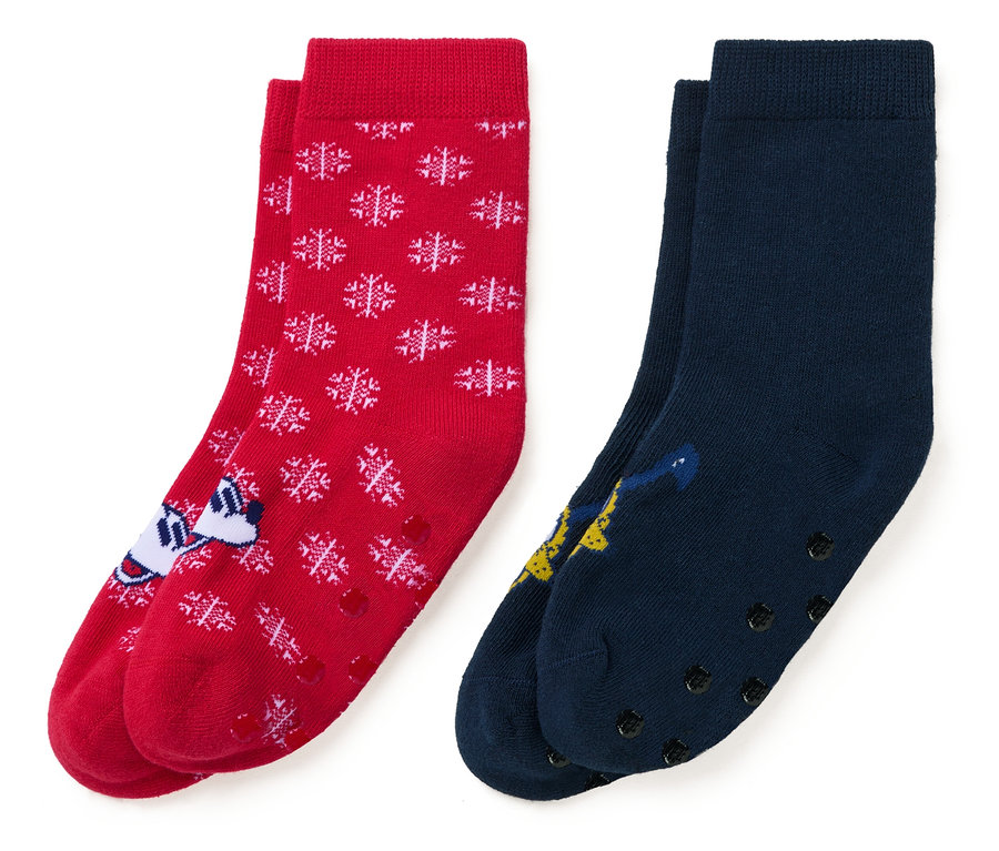 Deux paires de chaussettes : une rouge avec des flocons de neige blancs et un personnage de dessin animé, et une bleu marine avec un personnage de dessin animé.