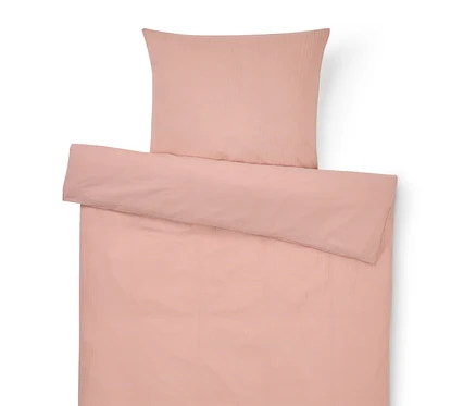 Vue de dessus d'une parure de lit rose comprenant une taie d'oreiller et une housse de couette.