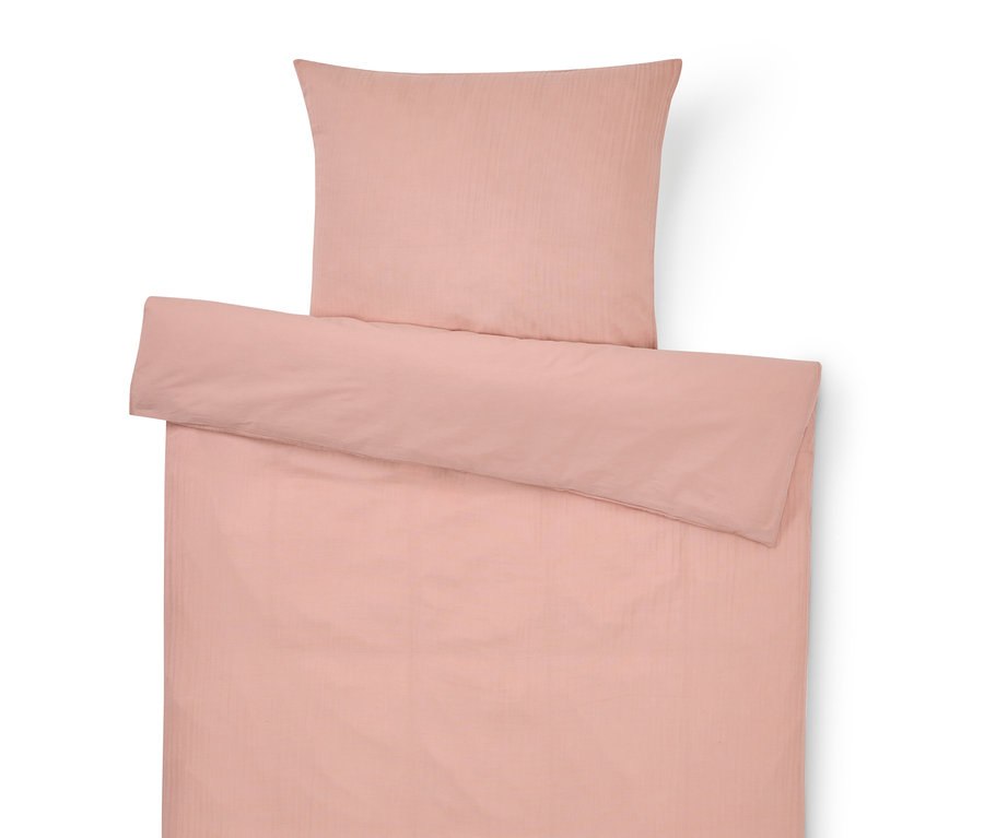 Vue de dessus d'une parure de lit rose comprenant une taie d'oreiller et une housse de couette.