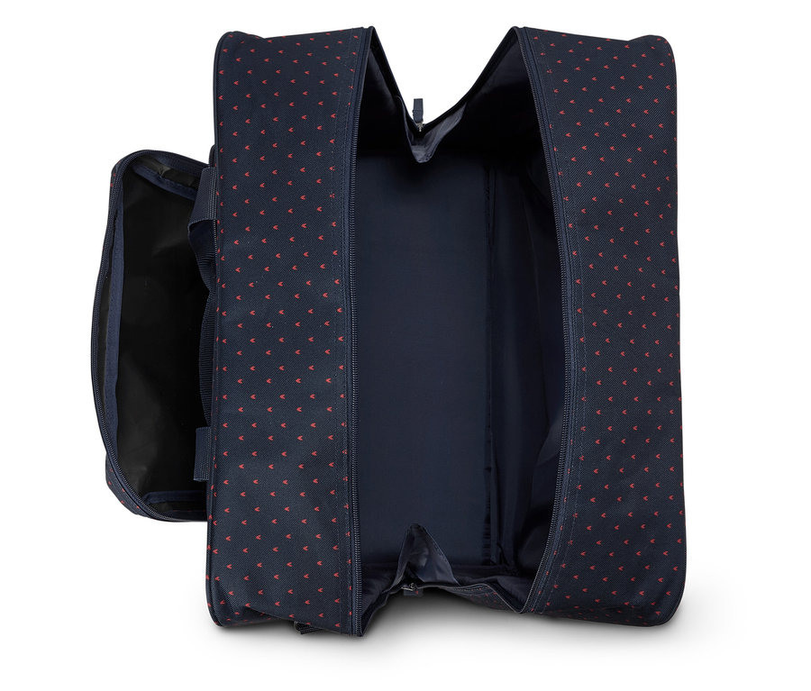 Sac de voyage bleu marine ouvert avec motif à pois rouges.
