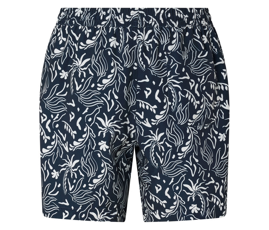 Gros plan sur un short bleu marine avec un imprimé de feuilles blanches.