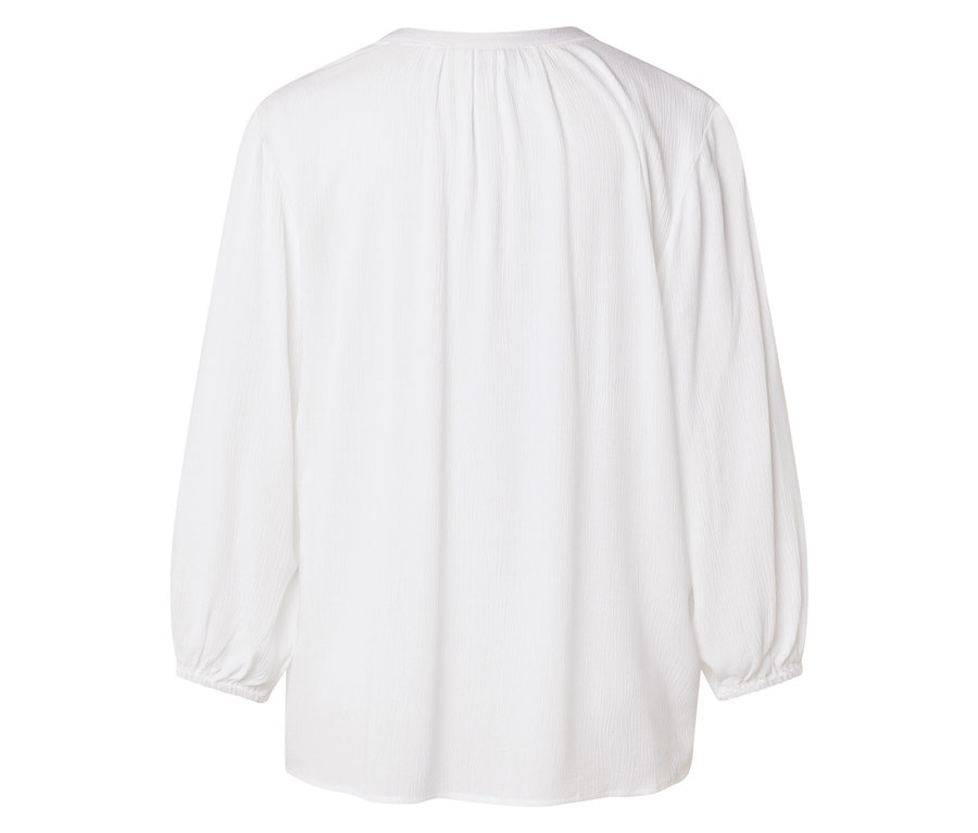 Vue arrière d'un chemisier blanc à manches longues.