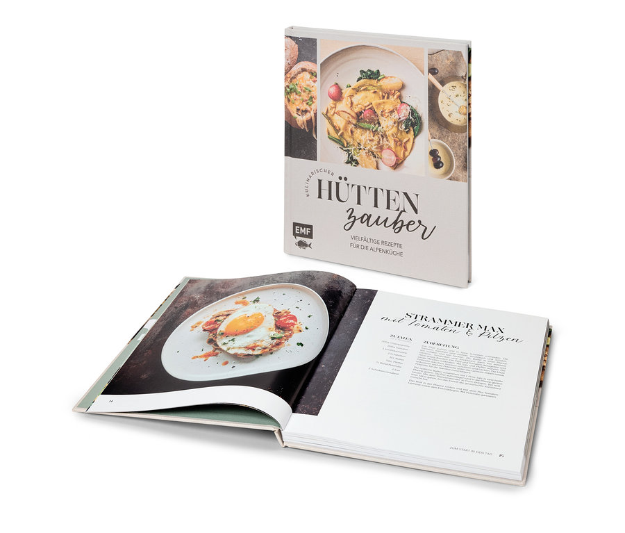 Livre de cuisine ouvert avec une recette pour "Strammer Max" et livre "Kulinarischer Hüttenzauber" derrière.