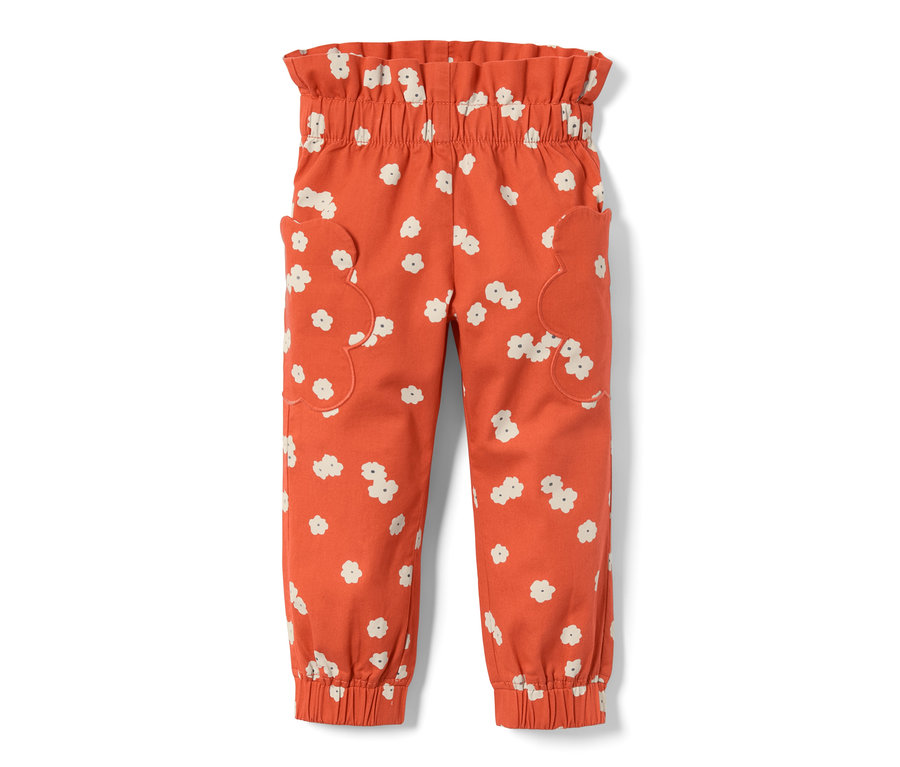 Pantalon élastique orange pour tout-petit avec imprimé à fleurs sur toute la surface.