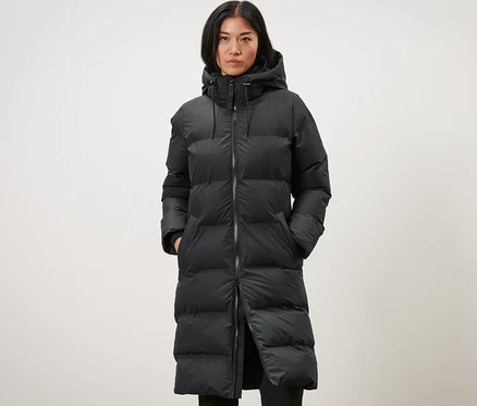 Femme portant un long imperméable d’hiver noir.
