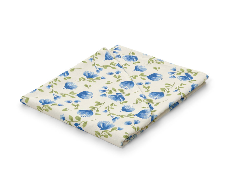 Nappe lavable pliée avec motif floral bleu.