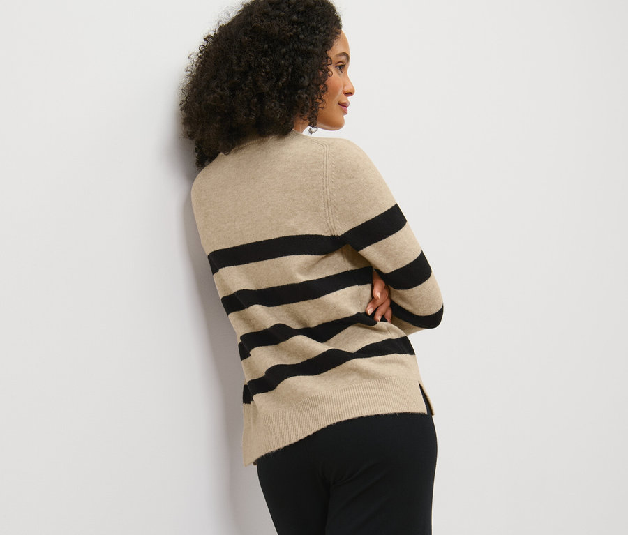 Femme posant en pull en maille à rayures.