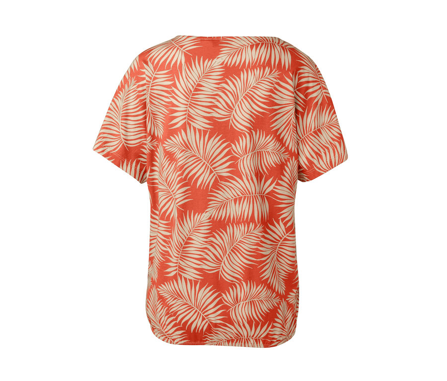 Vue détaillée de dos d'un chemisier imprimé orange et crème à motif de feuilles.
