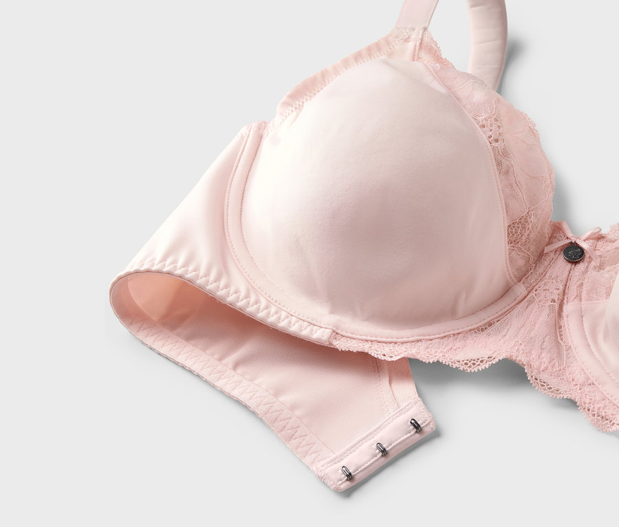 Soutien-gorge minimiseur rose avec détails en dentelle.