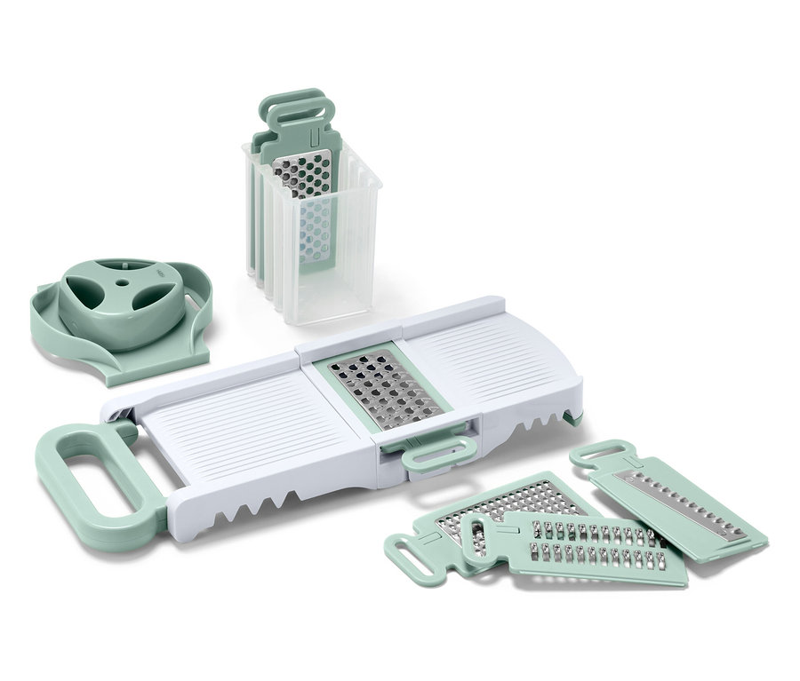Un ensemble de coupe-légumes et de râpes de cuisine avec un corps blanc et des détails vert clair.