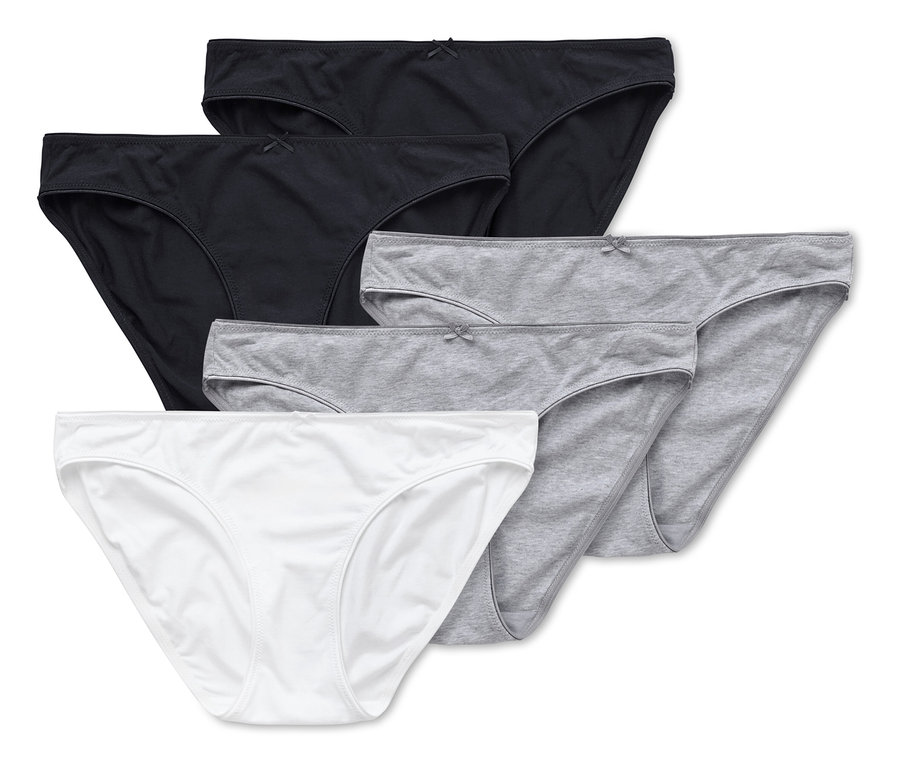 Cinq culottes en coton blanc, gris et noir sont superposées.