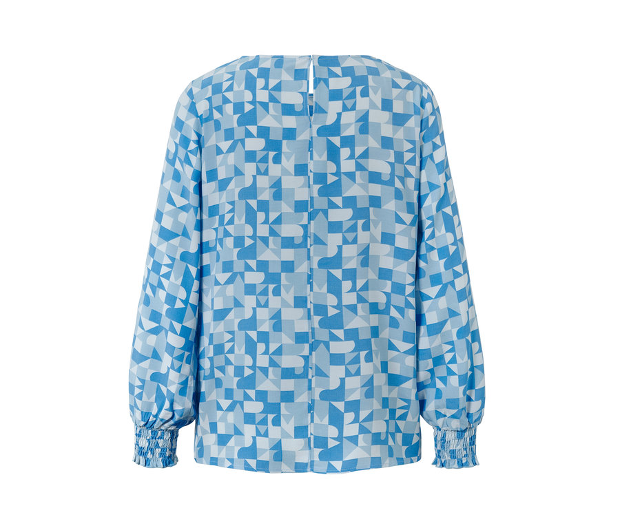 Chemisier imprimé bleu et blanc avec motif géométrique.
