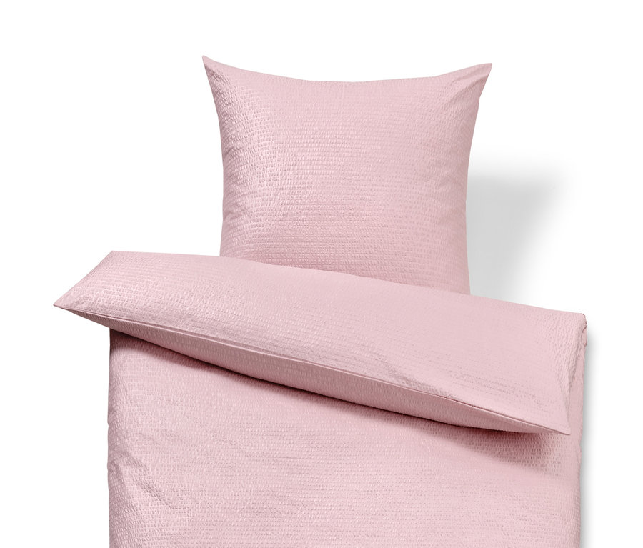 Parure de lit en seersucker rose avec oreiller.