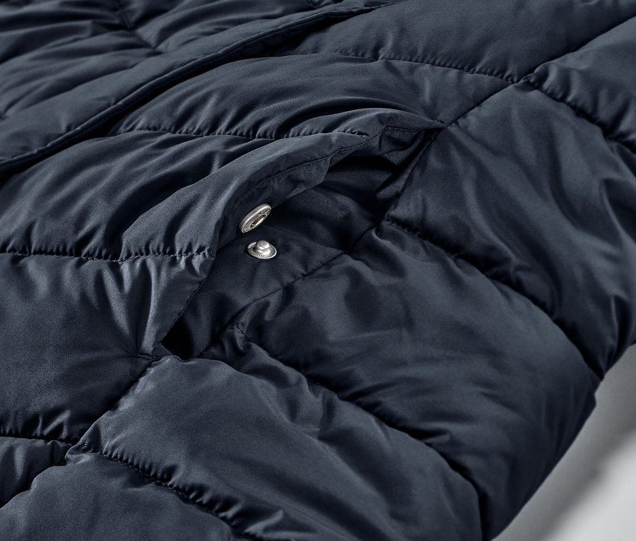 Vue détaillée d'un manteau matelassé à capuche bleu foncé.