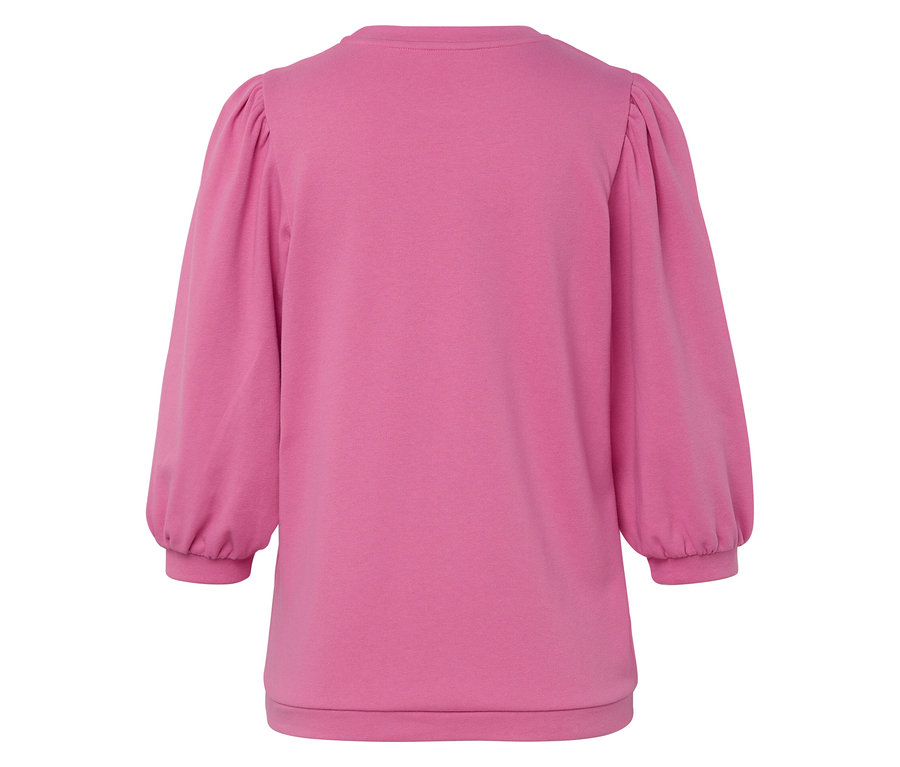 Gros plan sur un sweat-shirt rose à manches ballon.