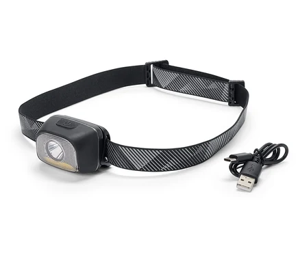 Une lampe frontale noire avec un bandeau à motifs gris et blancs et un câble de chargement USB.