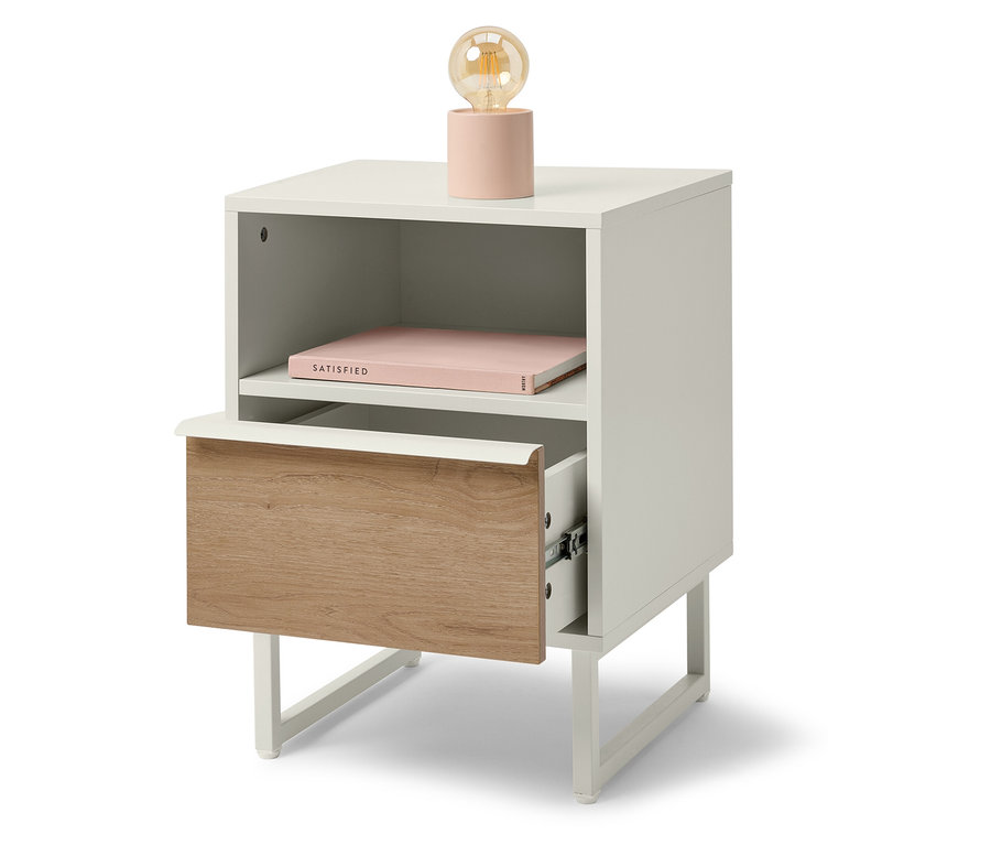 Table de chevet blanche avec tiroir en bois et lampe rose.