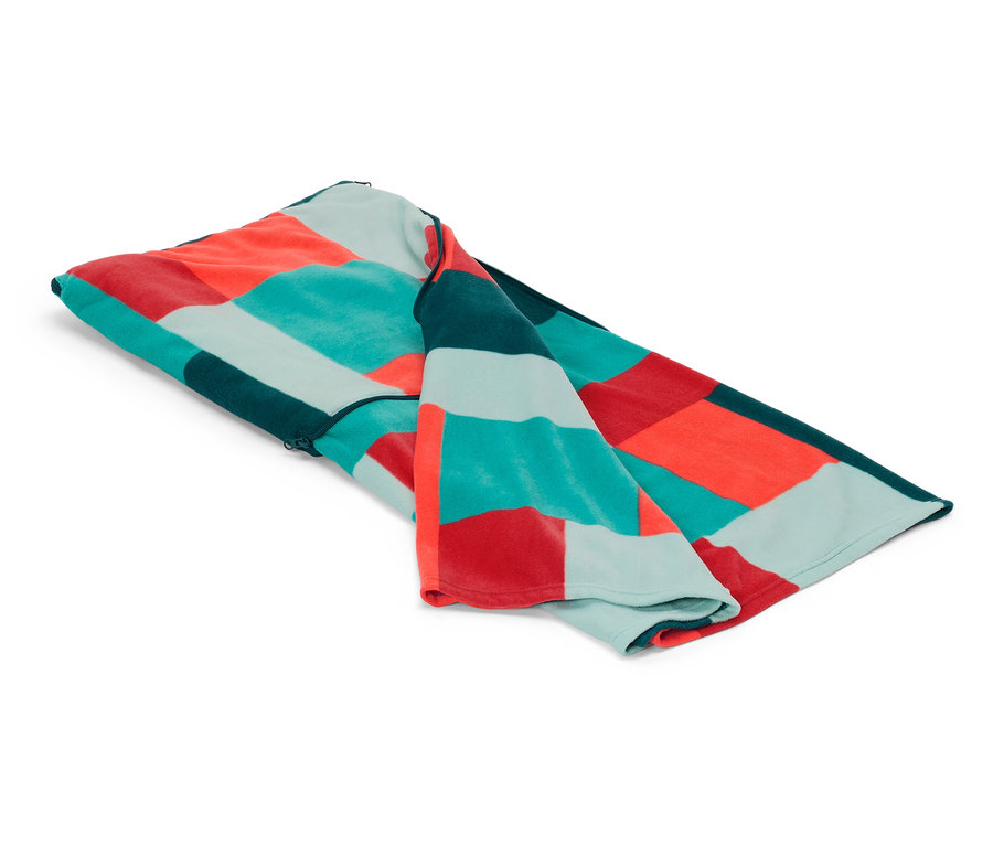 Une couverture pliée avec un motif géométrique de carrés rouges, turquoise et verts repose sur un fond blanc.