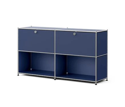 Meuble modulaire bleu foncé avec cadre argenté, comprenant deux compartiments supérieurs avec portes et deux compartiments inférieurs ouverts, sur fond blanc.