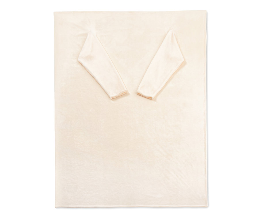 Une couverture moelleuse crème avec des manches intégrées est posée à plat sur un fond blanc.